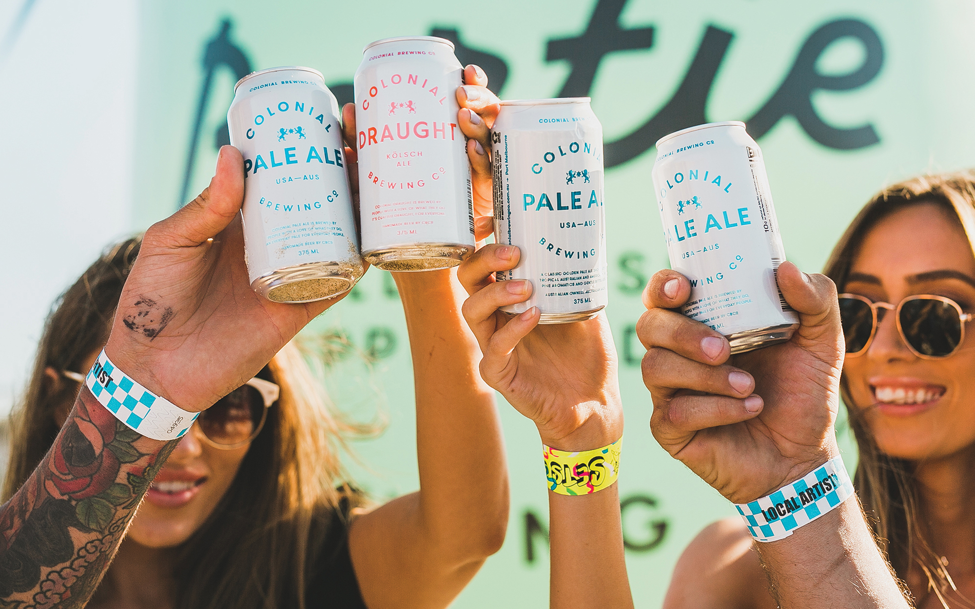 group of people cheersing with CBCo cans